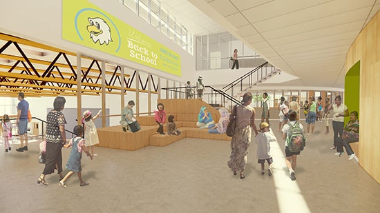 a large open space with a view into a lunchroom and some stairs leading up