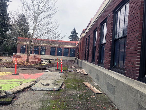 an L shaped brick building with windows