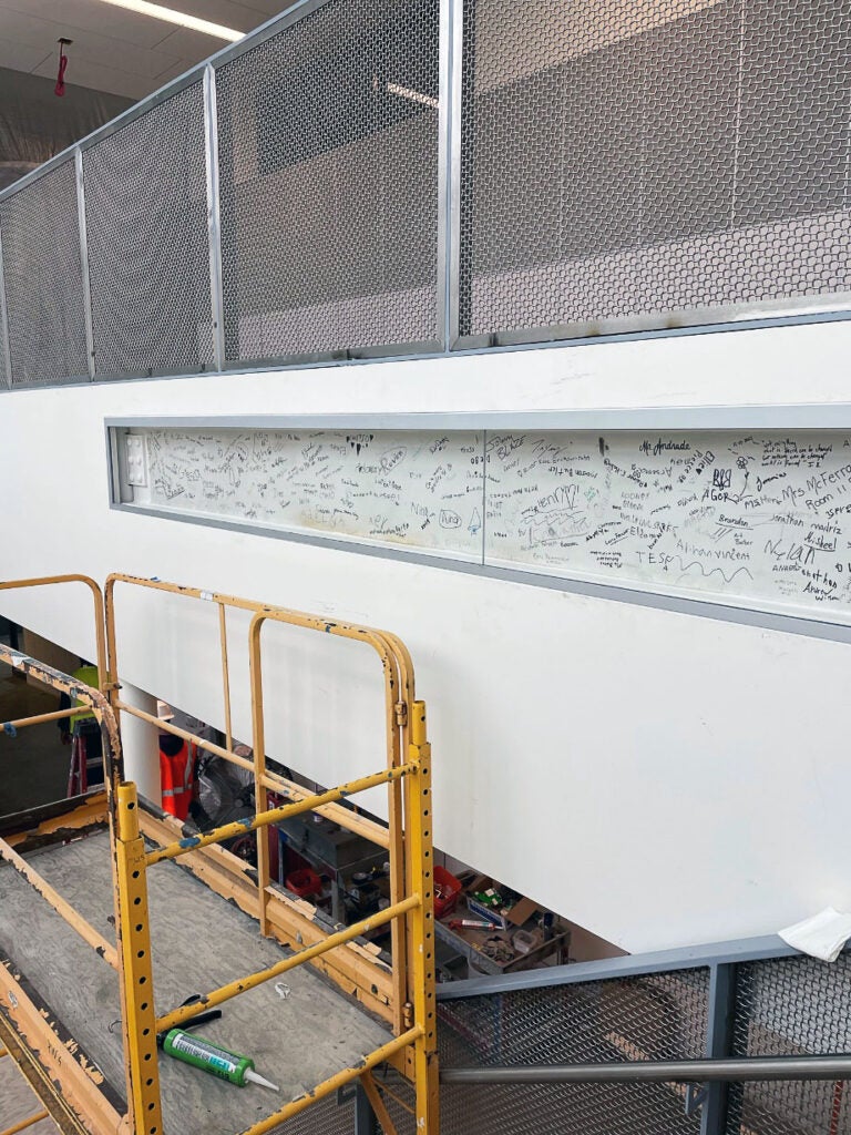 a wall on a stairwell has a signed steel beam embedded in it