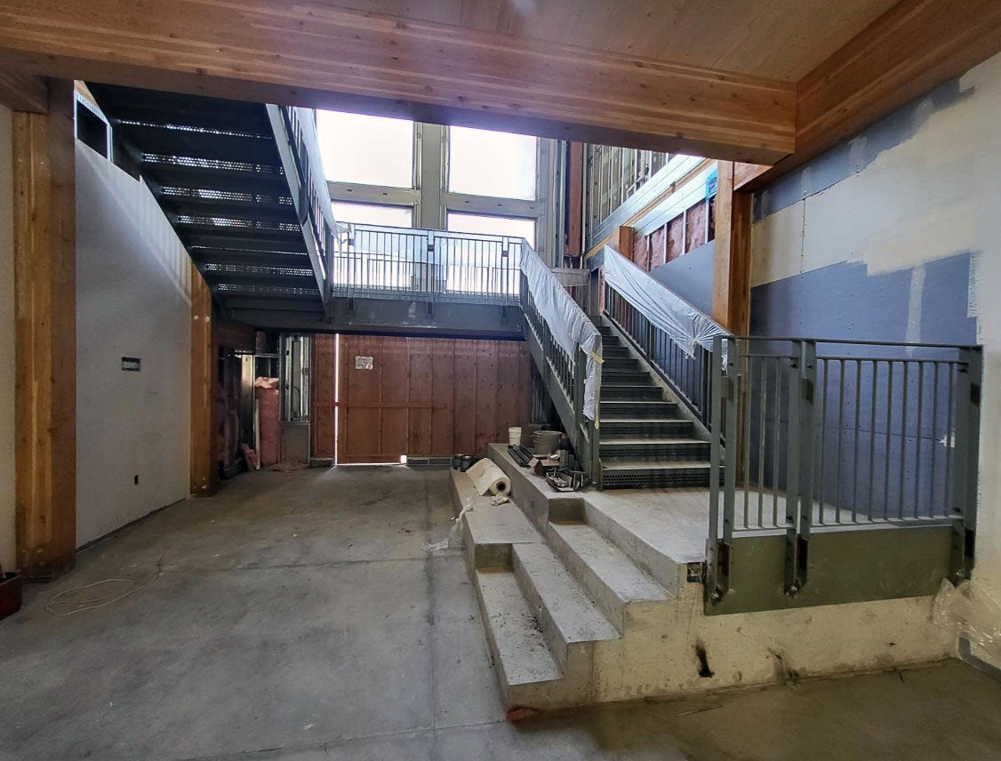 a stairway wraps up two levels to the next floor