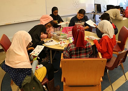 A group of students work on art projects in a classroom