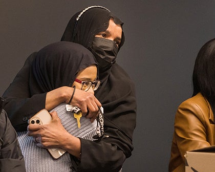 A student hugs a family member during the event.