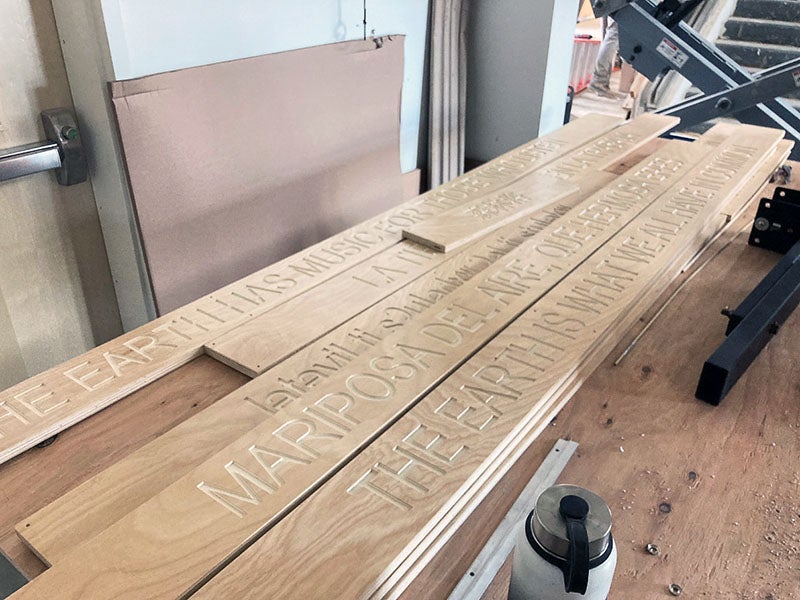 a pile of boards have words engraved on them