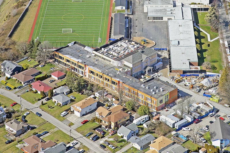 aerial view of a new building wrapped around a historic building