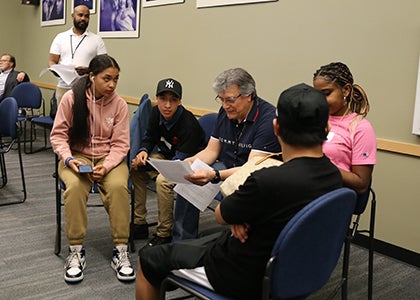 A group of students gather with an adult during the awards ceremony