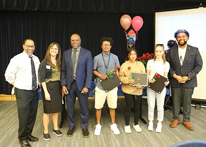 A school group pose for a photo with Superintendent Jones and School Board Director Hersey