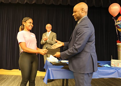 Superintendent Jones shakes hands with an awardee