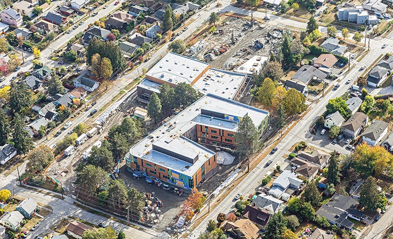 aerial photo of a large building with two wings and another large building attached
