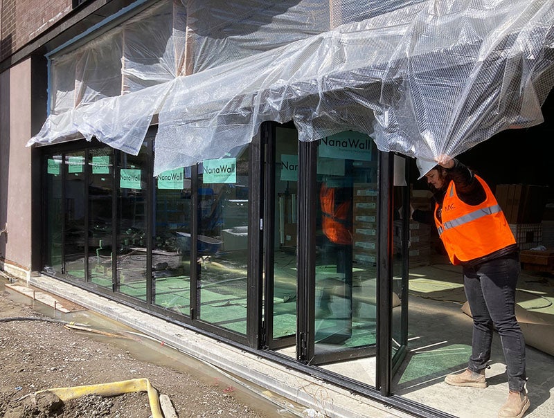 folding glass doors divide the outside from the inside of a building