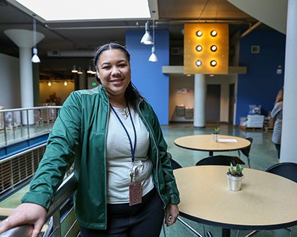 Savanna Willis standing inside John Stanford Center smiling at camera.