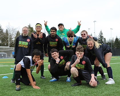 Roosevelt High Unified soccer team smiles and poses for the camera.