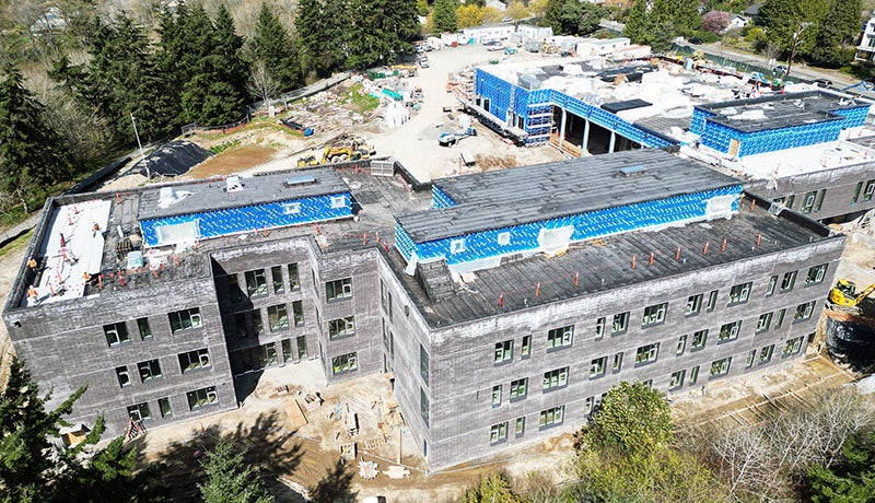 aerial view of a 3 story building with dark brick