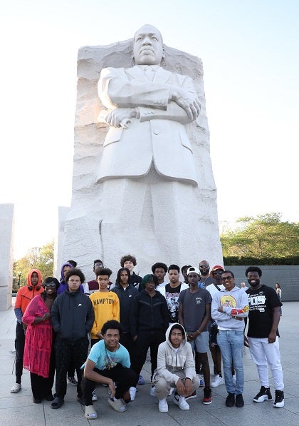 A group of students pose for a photo in front of the MLK Jr Memorial in DC