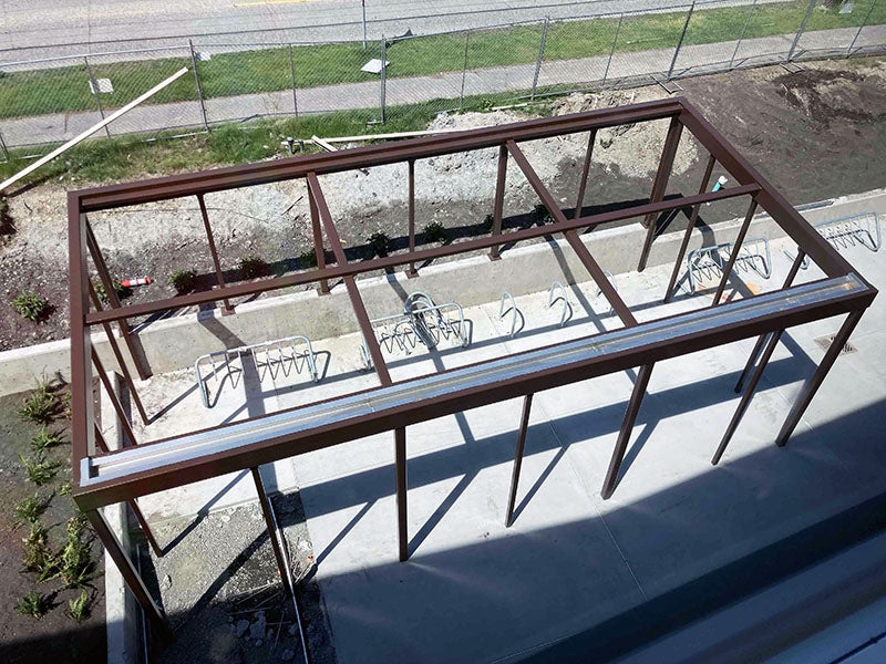 a view from above of a metal framed space with bike racks inside