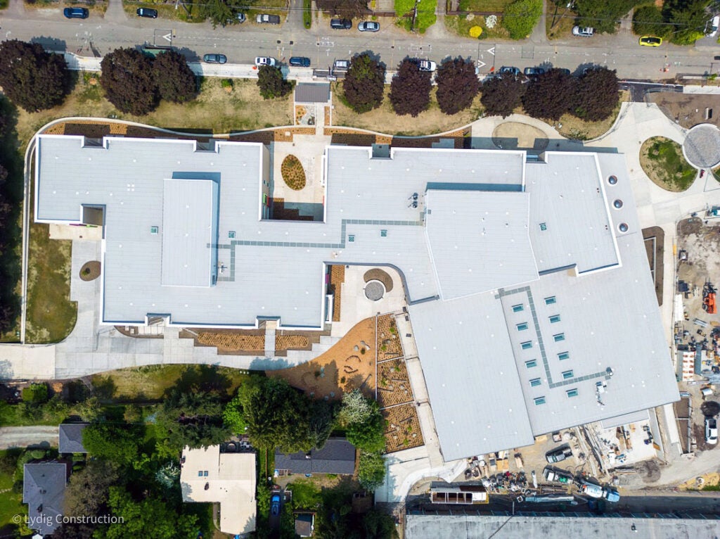 aerial view of a large building with a light colored roof