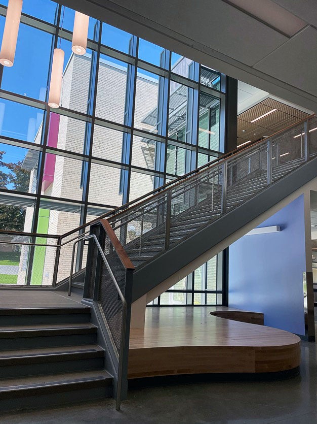 looking toward a stairway leading up in front of windows with a wooden platform underneath