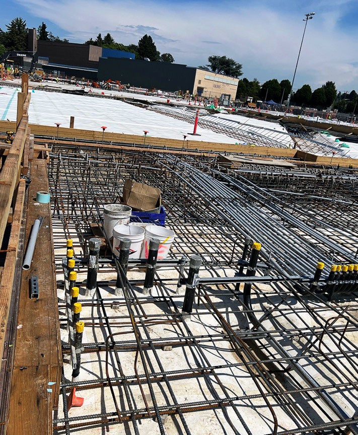 a grid of rebar inside a wood frame and a large area of white material spread behind it