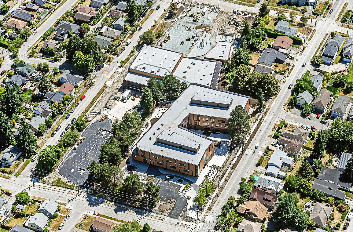 aerial view of two large buildings and a parking lot