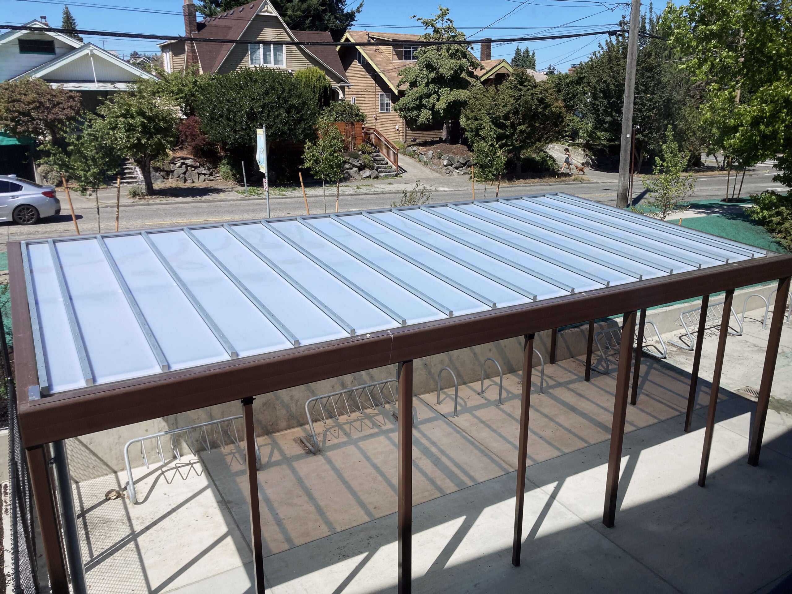 looking down at a white roof on a bike shelter