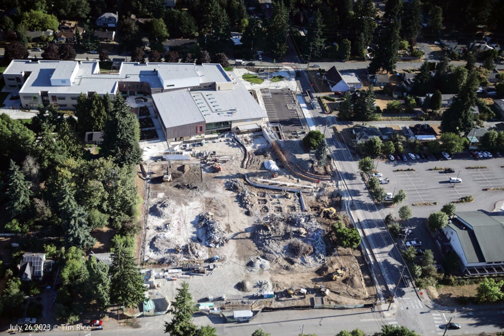 aerial view of a construction area next to a new building