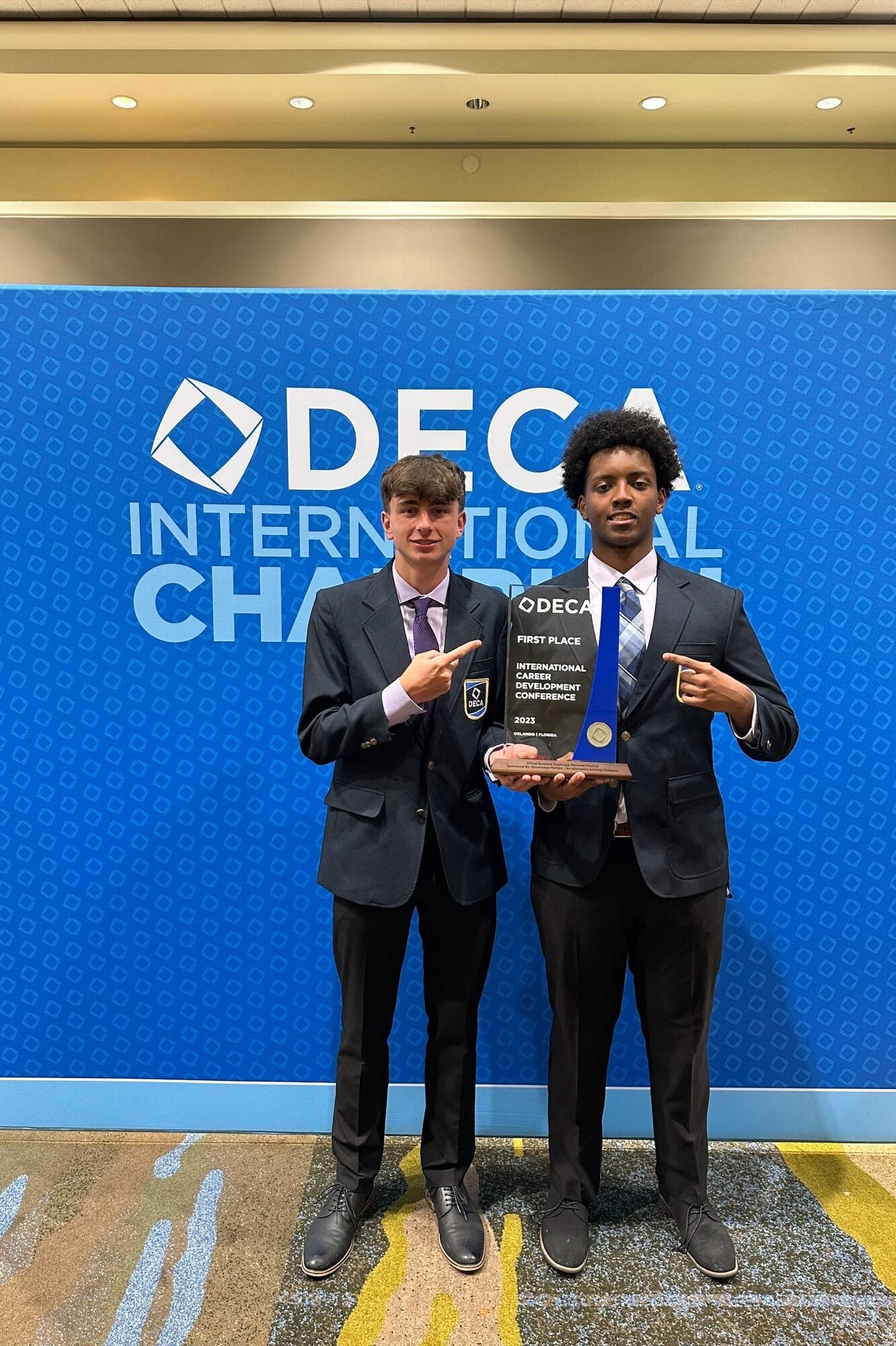 Students standing with award from DECA International Competition