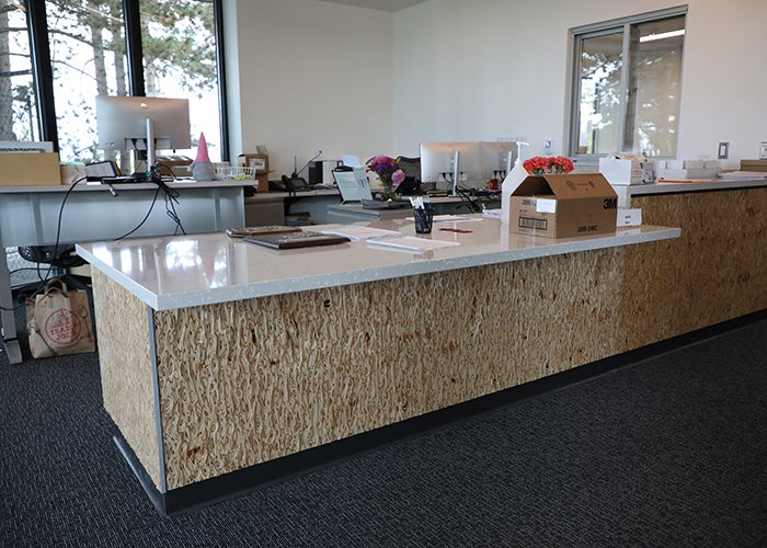 a room with a counter that has a textured wood front