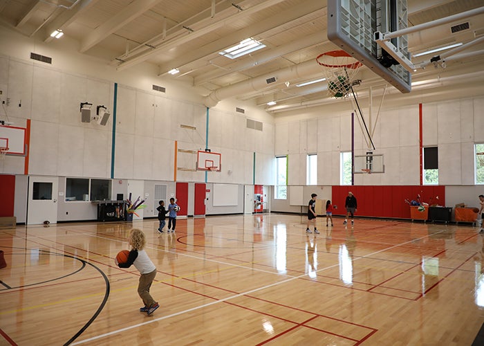 a gymnasium with children playing