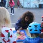 Lawton Elementary student makes bracelet at the school's back to school bash