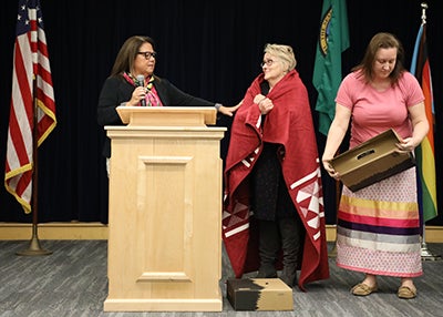 Staff present Director Harris with a blanket during the ceremony