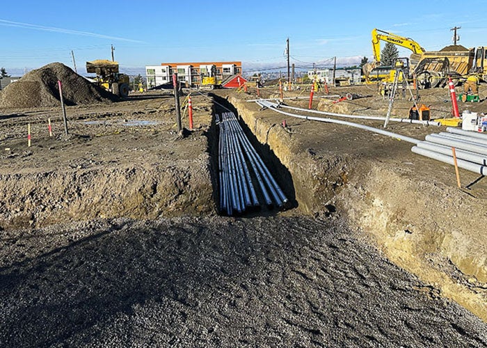 a trench with multiple lines of electrical conduit in it