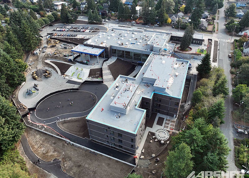 aerial photo of a large L shaped building on a sloped site