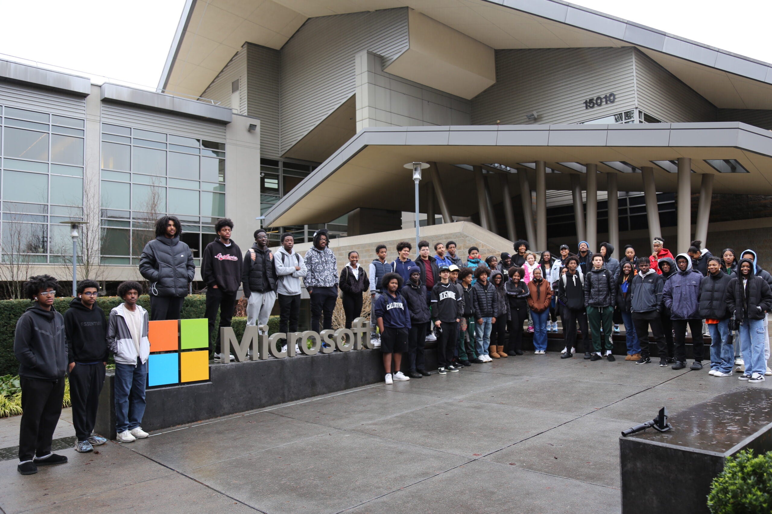 AAMA Students stand outside Microsoft, near a giant Microsoft sign.