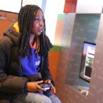 AAMA student plays video game at Microsoft.