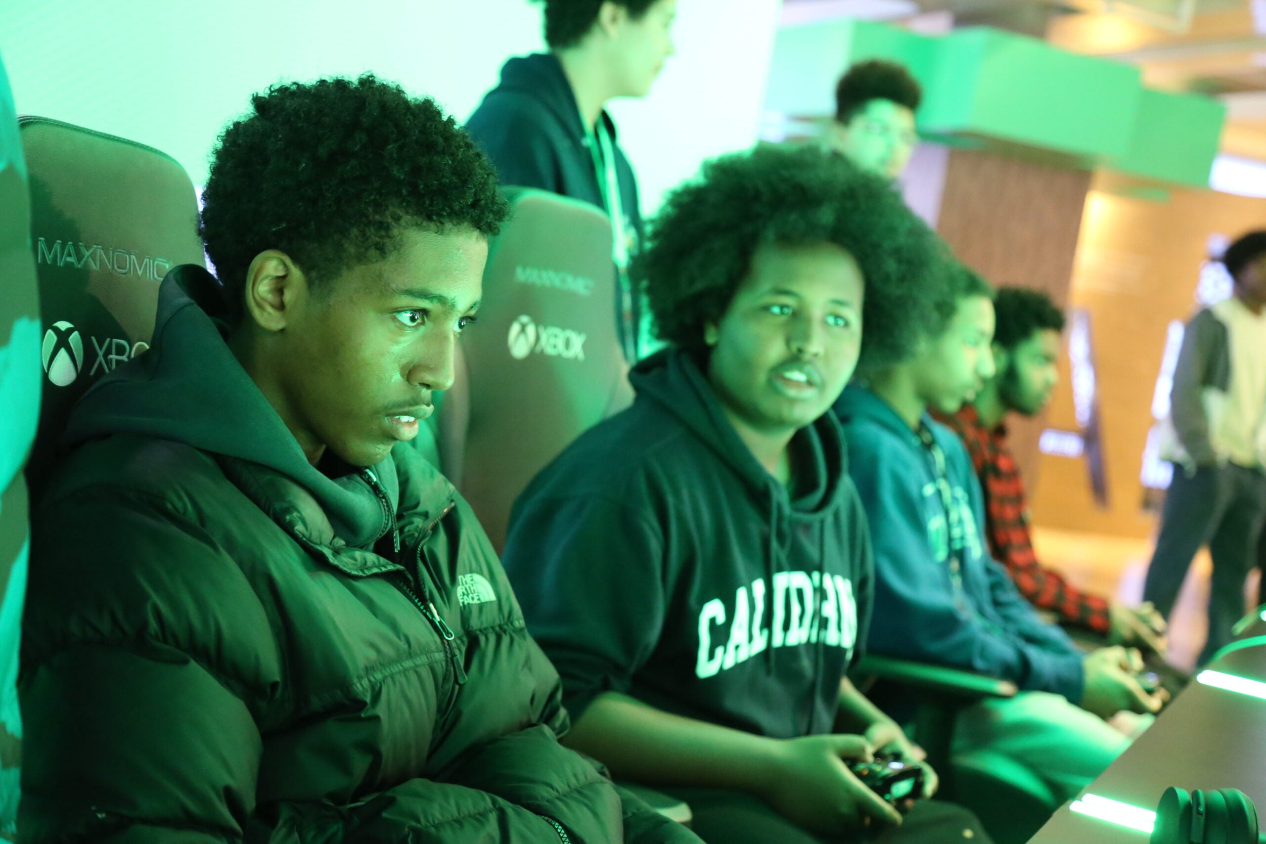 Two AAMA students play video games at Microsoft.
