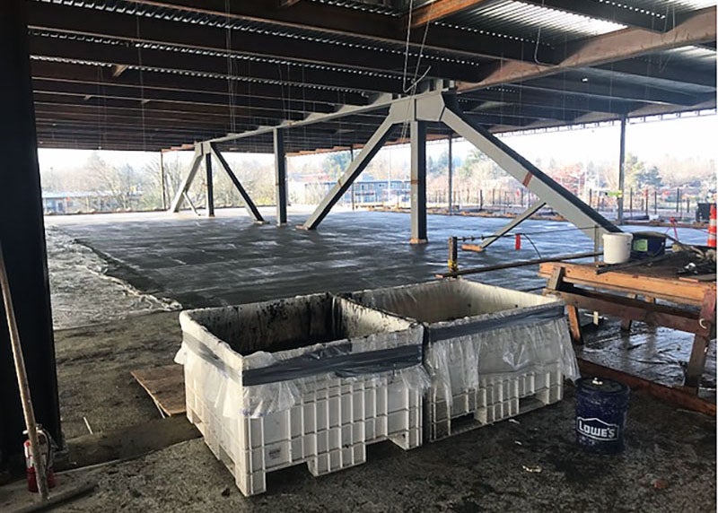 a concrete floor with steel framing and a view out the side showing it is up high