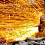 Sparks flying in close up metalworking picture