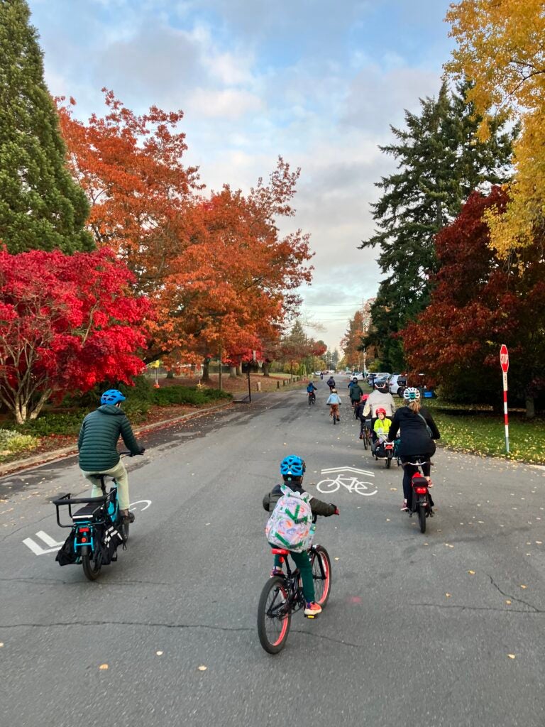 a group of students biking on the street