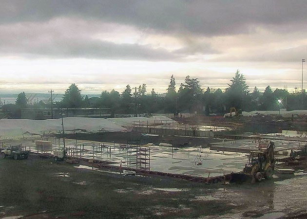 aerial view of a construction site that is still mostly flat and has some equipment on it