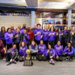 GarfiGarfield High Girls Basketball teams smiles at camera with state trophy.