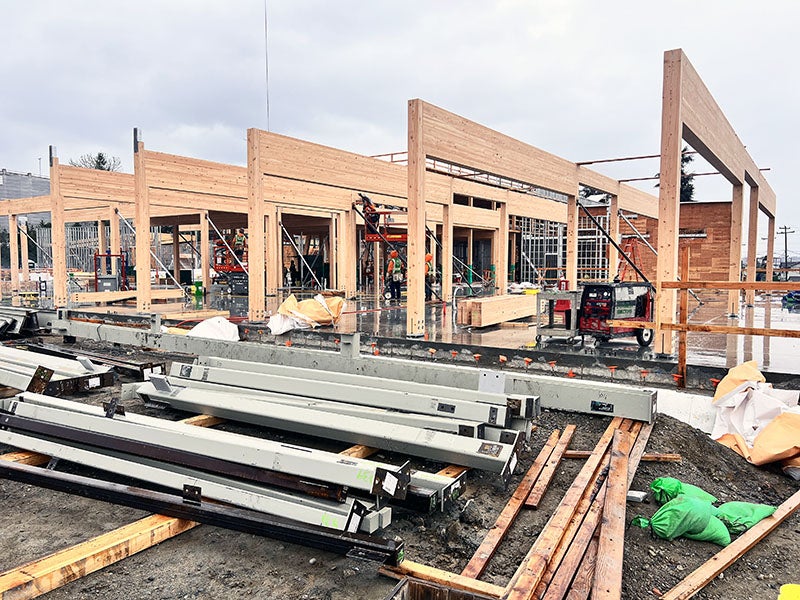 a row of frames made of columns and beams with steel on the ground in front
