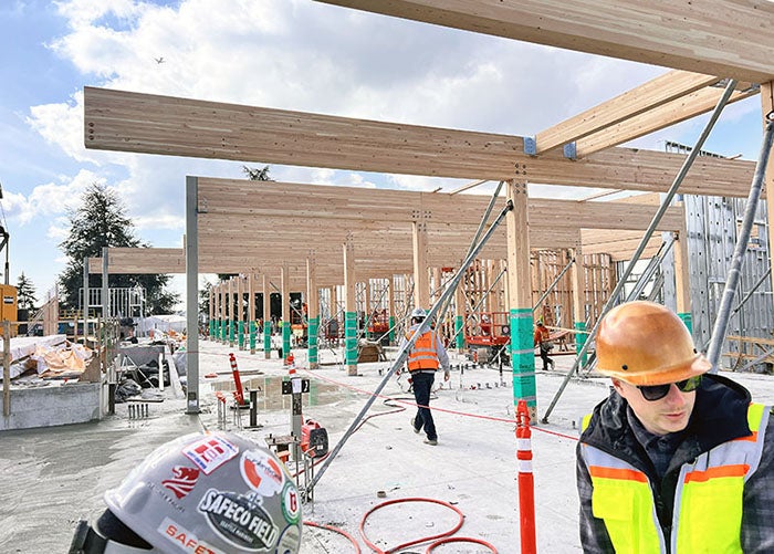 a building is under construction with large cross-laminated timber beams and tibler posts