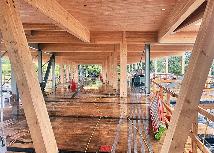a large open space with laminated timber beams and wall supports and cross laminated decking
