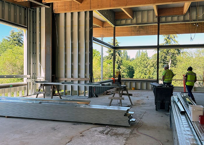 inside a partially built room with wood beams and steel framing