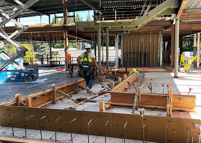 wood framing on a concrete floor inside a partially constructed building