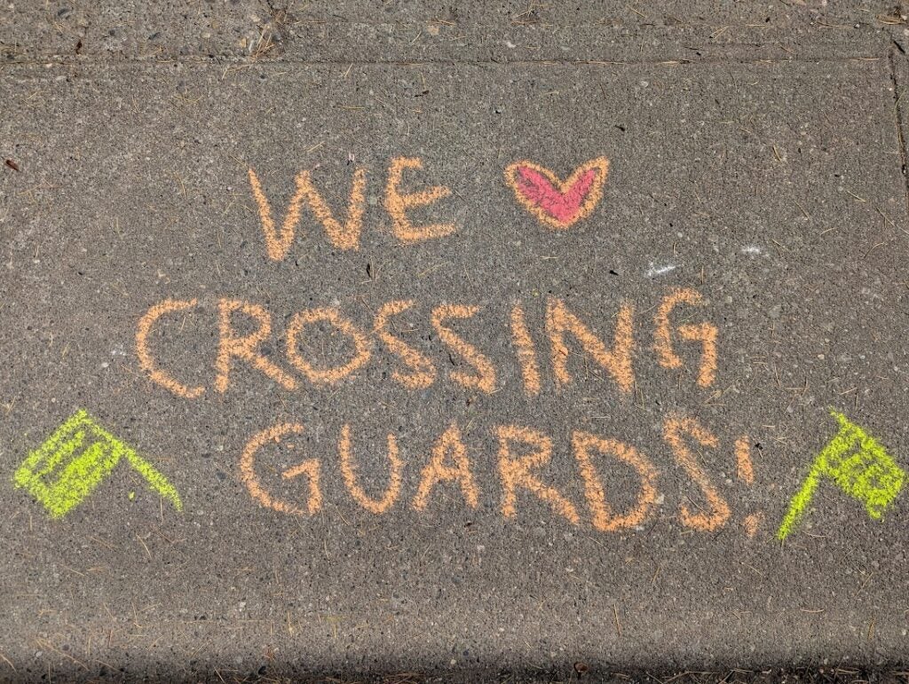 Chalk on sidewalk We heart crossing guards