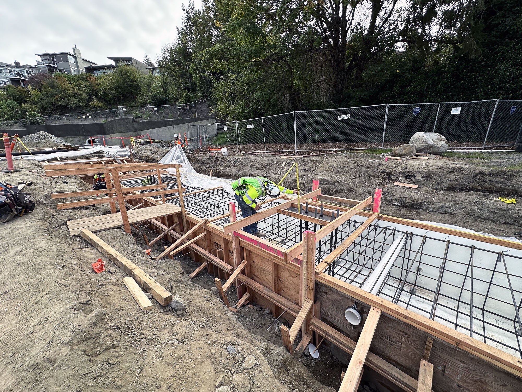 a person is working on a frame with rebar within a construction site