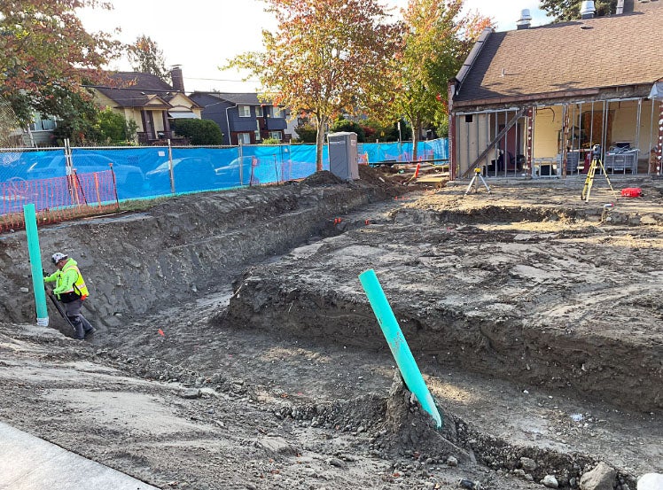 a large trench outside of a building with one wall open
