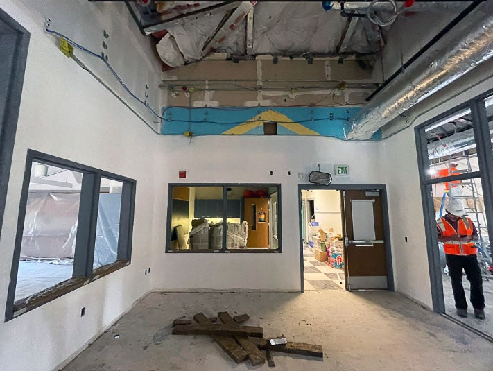 a hallway with an open ceiling under construction