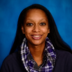 A woman is smiling in front of a blue background.
