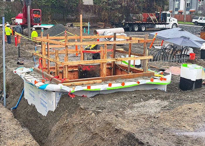 a wood frame over a hole in the dirt